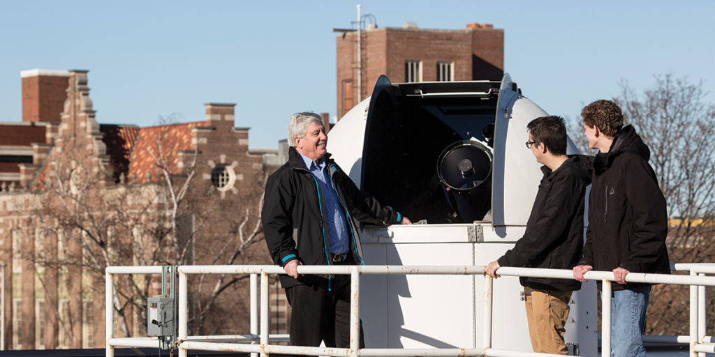 Dr. Peter Gonthier and Calvin Gentry Class of 2018, and Josiah Brouwer Class of 2018 on the roof of an observatory.