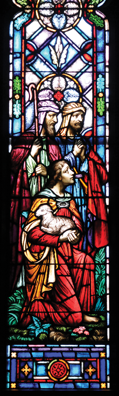 A scene from the Chancel window of Dimnent Memorial Chapel. In vibrant colors of stained glass, three shepherds and a lamb are symbolic of the birth of Christ.