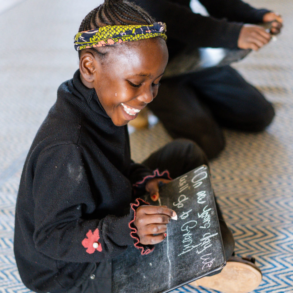 Child practicing writing in Kenya