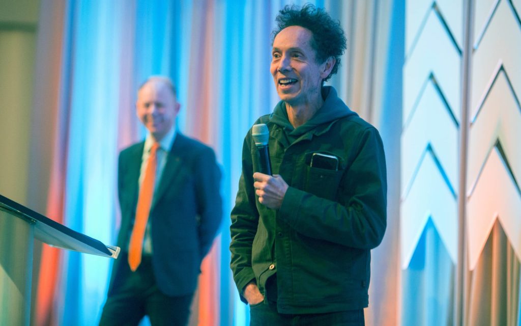 Malcolm Gladwell and President Matt Scogin on stage at The Catalyst Summit